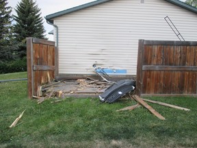 RCMP handout image of damage to an Airdrie home struck by a vehicle Wednesday.