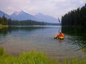 A man fishes on Johnson Lake. Parks Canada has decided to remove fish from the lake in an effort to contain whirling disease.