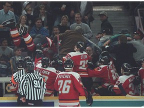 All hell breaks loose in Edmonton. During a game in November of 1996 shown nationally on Hockey Night in Canada, the Falmes' Sasha Lakovic, left, went into the Edmonton crowd after a drunk fan poured a beer over the head of Calgary coach Guy Lapointe.