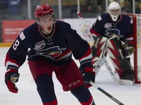 Brooks Bandits defenceman Cale Makar challenges a player for the puck in the Bandits' defensive zone during AJHL action against the Fort McMurray Oil Barons at the Casman Centre in Fort McMurray Alta. on October 27, 2016.