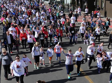 Runners and walkers stride off the start at the Sport Chek Mother's Day Run and Walk at Chinook Centre on Sunday May 14, 2017. The event supports neonatal units in Calgary as well as Jumpstart for Kids.