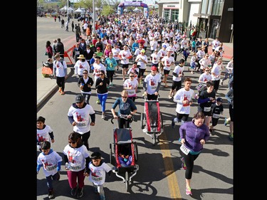 Runners and walkers stride off the start at the Sport Chek Mother's Day Run and Walk at Chinook Centre on Sunday May 14, 2017. The event supports neonatal units in Calgary as well as Jumpstart for Kids.