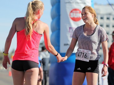 Top finishers in the 5 km event shake hands at the finish line of the Sport Chek Mother's Day Run and Walk at Chinook Centre on Sunday May 14, 2017. The event supports neonatal units in Calgary as well as Jumpstart for Kids.