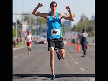 The 5km men's winner crosses the line at the Sport Chek Mother's Day Run and Walk at Chinook Centre on Sunday May 14, 2017. The event supports neonatal units in Calgary as well as Jumpstart for kids.
