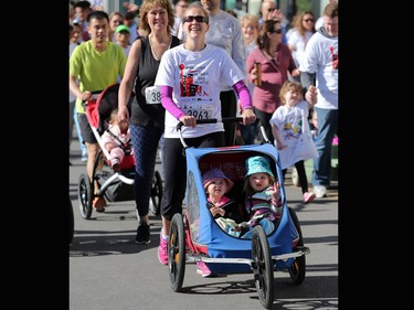 Runners and walkers stride off the start at the Sport Chek Mother's Day Run and Walk at Chinook Centre on Sunday May 14, 2017. The event supports neonatal units in Calgary as well as Jumpstart for Kids.