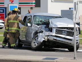 Calgary firefighters work at the scene of a collision between a semi truck and a Honda Ridgeline at the intersection of 52nd Street and Madigan Drive on Saturday May 27, 2017. One person was taken to hospital in life-threatening condition. Gavin Young/Postmedia Network