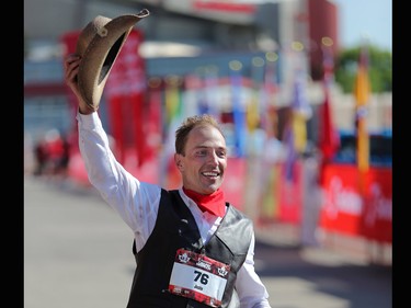 Justin Kurek crosses the line after setting the Guinness World Record for fastest marathon dressed in a cowboy outfit at the Scotiabank Calgary Marathon on Sunday May 28, 2017.