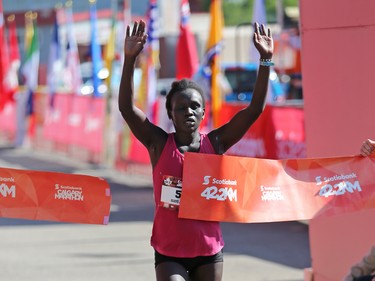 Gladys Tarus crosses the line in first place in the women's division in the Scotiabank Calgary Marathon on Sunday May 28, 2017.