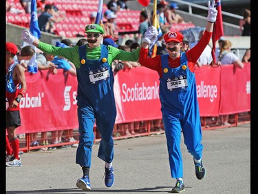 Ben and Daniel Sopher cross the line as the Super Mario brothers in the half marathon event at the Scotiabank Calgary Marathon on Sunday May 28, 2017.