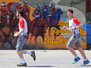 Runners pass a mural at Stampede Park as they head towards the finish at the Scotiabank Calgary Marathon on Sunday May 28, 2017.