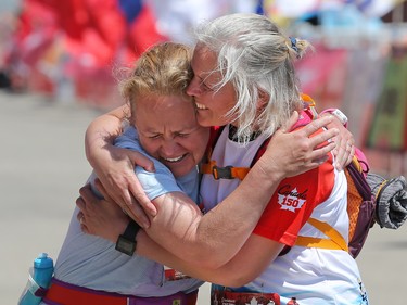 Julie Paprocke, left and Lisa Redhead hug after finishing the Scotiabank Calgary Marathon on Sunday May 28, 2017.
