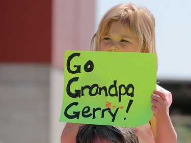 Lyra Miller gets ready to cheer for her grandpa Gerry with dad Jeff near the finish line of the Scotiabank Calgary Marathon on Sunday May 28, 2017. Gerry was one of the members of the  Guinness World Record team from MitoCanada trying to break the record for the most number of runners tied together for a marathon