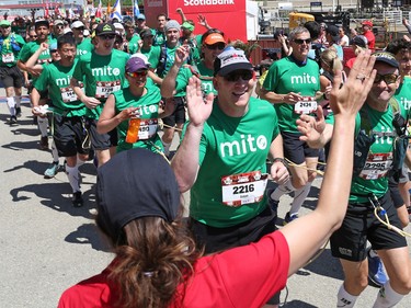 The MitoCanada Calgary Marathon Team crosses the finish line with over 100 runners tied together to set a Guinness World Record at the Scotiabank Calgary Marathon on Sunday May 28, 2017.