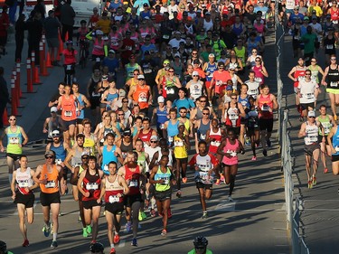 The lead marathoners and half marathoners race off down the starting stretch of the Scotiabank Calgary Marathon on Sunday May 28, 2017.