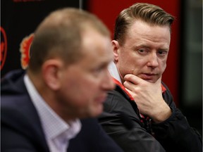 Calgary Flames GM Brad Treliving, left and head coach Glen Gulutzan speak with the media at the Scotiabank Saddledome in Calgary, Alta. on Friday April 21, 2017.