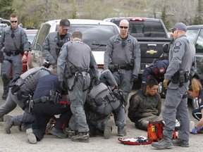 Calgary Police take into custody two men after a collision on Parkdale Blvd and Shaganappi Tr NW about 1 pm in Calgary on Tuesday May 9, 2017. The alleged stolen vehicle crashed into at least two other vehicles. The men were taken into custody in a parking lot near Edworthy Park. The were treated at scene by EMS for a variety of injuries. Jim Wells//Postmedia