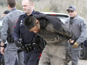 Calgary Police take into custody two men after a collision on Parkdale Blvd and Shaganappi Tr NW about 1 pm in Calgary on Tuesday May 9, 2017. The alleged stolen vehicle crashed into at least two other vehicles. The men were taken into custody in a parking lot near Edworthy Park. The were treated at scene by EMS for a variety of injuries. Jim Wells//Postmedia