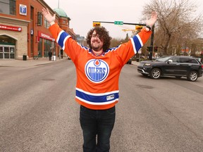 Graham Mosimann, local radio dj and a huge Edmonton Oilers fan, braves traffic in a busy intersection on what used to be the world famous Red Mile (17 Ave SW) in Calgary on Tuesday May 2, 2017. Jim Wells//Postmedia