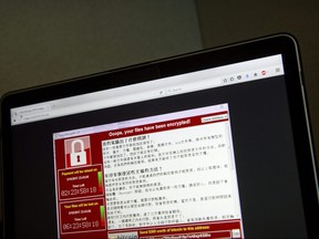 FILE - In this May 13, 2017 file photo, a screenshot of the warning screen from a purported ransomware attack, as captured by a computer user in Taiwan, is seen on laptop in Beijing.  Global cyber chaos is spreading Monday, May 14,  as companies boot up computers at work following the weekend's worldwide "ransomware" cyberattack. The extortion scheme has created chaos in 150 countries and could wreak even greater havoc as more malicious variations appear. The initial attack, known as "WannaCry," paralyzed computers running Britain's hospital network, Germany's national railway and scores of other companies and government agencies around the world.  (AP Photo/Mark Schiefelbein, File) ORG XMIT: TKSK401