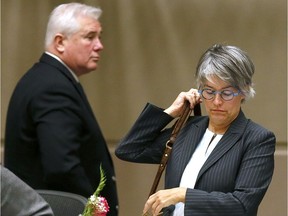 Coun. Ward Sutherland walks past Coun. Druh Farrell during Monday's council meeting.