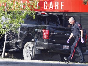 CPS are investigating after a Ford F150 truck hit a white Toyota car and a pedestrian in the parking lot area of Sunridge Mall in Calgary, Alta., on May 23, 2017. The F150 ended its drive embedded in in the side of the Co-Op health medicine store. Ryan McLeod/Postmedia Network