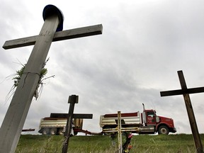 A truck passes a roadside memorial for victims of a May 20, 2005 crash on Highway 28 north of Gibbons, Alta.