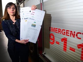 Suzanne Oel, Foothills Regional 911 Commission chair holds letters of support from all municipalities in her region to the Minister of Health titled "Municipal Support for the Return of EMS Dispatch to FRESC" in Priddis, Alta., on May 5, 2017. Ryan McLeod/Postmedia Network