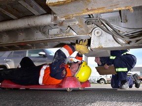 Constable Paul Schweyer, left, and Const. Graham Dunn inspect a truck during a three-day commercial vehicle inspection blitz in Calgary, Alta. between May 16 and May 18.