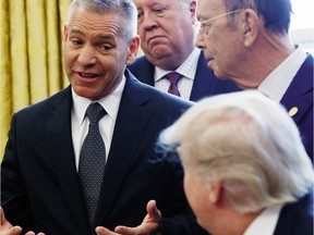 TransCanada CEO Russell K. Girling speaks to President Donald Trump in the Oval Office of the White House in Washington, Friday, March 24, 2017, during an announcement on the approval of a permit to build the Keystone XL pipeline, clearing the way for the $8 billion project.