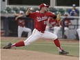 Okotoks' Liam Stroud pitches during a playoff game between the Edmonton Prospects and the Okotoks Dawgs at Telus Field in Edmonton, Alberta on Tuesday, August 2, 2016.