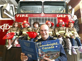 Calgary Firefighter Assistant Deputy Chief Coby Duerr reads to students from the Village Square Play School with Engine 23 which was donated to the Calgary Public Library by the Calgary Fire Department, making way for a unique partnership that will see firefighters giving of their time to read to children and share life-saving fire safety tips during drop-in storytimes on Wednesday May 3, 2017. DARREN MAKOWICHUK/Postmedia Network