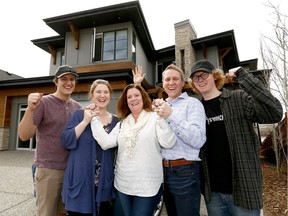 Foothills Hospital Home Lottery Grand Prize winner Patti Williams with husband Trevor and family L-R, Zach, Grace and Matthew in front of their new Grand Prize Showhome at 59 Cranbrook Lane S.E. worth 2.4 million on Thursday May 4, 2017. DARREN MAKOWICHUK/Postmedia Network