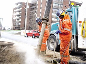 Employees with Badger Daylighting, clear a trench to make way for Hydro One underground cable work.