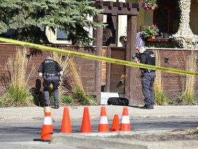 Calgary police investigate the scene of an early-morning shooting on Elbow Drive SW on Saturday, May 20.