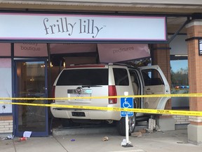 Calgary police investigate after a car drove through the windows of the Frilly Lilly in Shawnessy sending a young boy to hospital with serious injuries on Saturday May 13, 2017. DARREN MAKOWICHUK/Postmedia Network