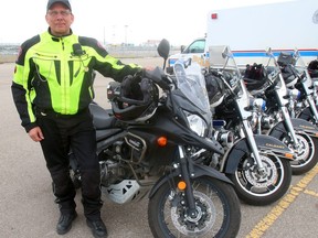 Cst. Phil Anderson stands beside a Suzuki V-Strom 650 motorcycle that the Calgary Police Service has been using. The Traffic Unit will be rolling out an additional 6 new V-Strom 1000 bikes this Spring. Friday May 5, 2017 in Calgary, AB. DEAN PILLING/POSTMEDIA