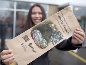 Kimberlie Crowe, 17, holds up her winning liquor bag design, in Calgary on Wednesday May 17, 2017,  illustrating the dangers of impaired driving Leah Hennel/Postmedia