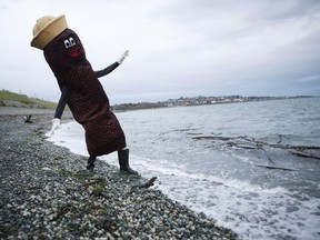 Local sewage activist James Skwarok, also known as Mr. Floatie, dips his boot into the water near Clover Point in Victoria, B.C.