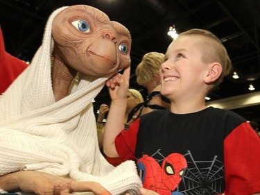 Milo Nolin,7, meets E.T.  during the 12th Annual Calgary Comic & Entertainment Expo (Calgary Expo) which runs from Thursday to Sunday at Stampede Park on Saturday April 29, 2017. DARREN MAKOWICHUK/Postmedia Network