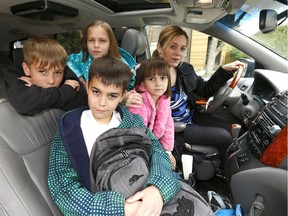Mom Sarah Bieber with her kids L-R, Kai,10, Halle,8, Cora,6, and Jayce,11, who go to three different schools in Calgary are not happy about the CBE overhauling their transportation system, including big changes to bell times on Wednesday May 17, 2017. DARREN MAKOWICHUK/Postmedia Network