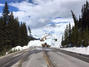 Parks Canada road crews work to clear avalanche debris from the Icefields Parkway in Banff National Park on May 5.