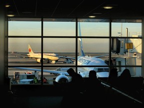 Passengers are silhouetted in the terminal at Vancouver International Airport.