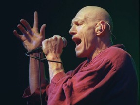 Peter Garnett is shown in concert with Midnight Oil.