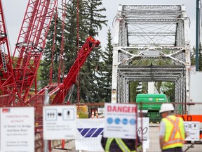 A massive crane, left, waits in position to remove the original 12th Street Bridge over the Bow River to St. George's Island on Wednesday May 24, 2017. The move was postponed due to the high winds. Gavin Young/Postmedia Network