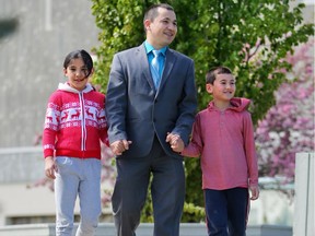Malik Muradov was photographed walking with his children Meryem, 10, left and Musa, 8 on Thursday May 25, 2017 for a story about the start of Ramadan. Gavin Young/Postmedia Network