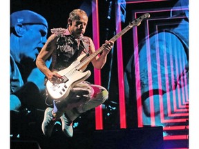 Bassist Flea, of the Red Hot Chili Peppers, lets loose before a sellout crowd at the Scotiabank Saddledome.