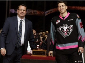 Calgary Hitmen general manager Mike Moore stands with Calgary Hitmen forward Matteo Gennaro, who won Player of the Year during the team's awards night on March 18, 2017. (Gavin Young)