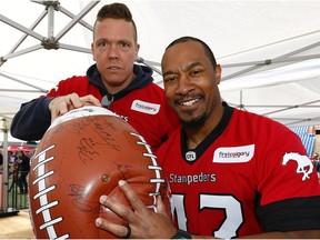 Stamps Dan Federkeil, left, and Deron Mayo pose with oversize football as an excess of 9,000 fans turned up at McMahon Stadium on Saturday for the 2017 edition of Fanfest. The annual event serves as the unofficial kickoff for the Stampeders football season in Calgary, Alta., on Saturday, May 13, 2017.