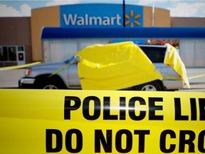 Police tape surrounds an SUV in a parking lot at the Walmart on 130th ave. in the city's southeast . Police are still investigating.