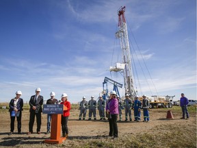 Farmer Scott Irvine, far right, looks on as Premier Rachel Notley and Alberta Energy Minister Margaret McCuaig-Boyd announce the cleanup plan Thursday.